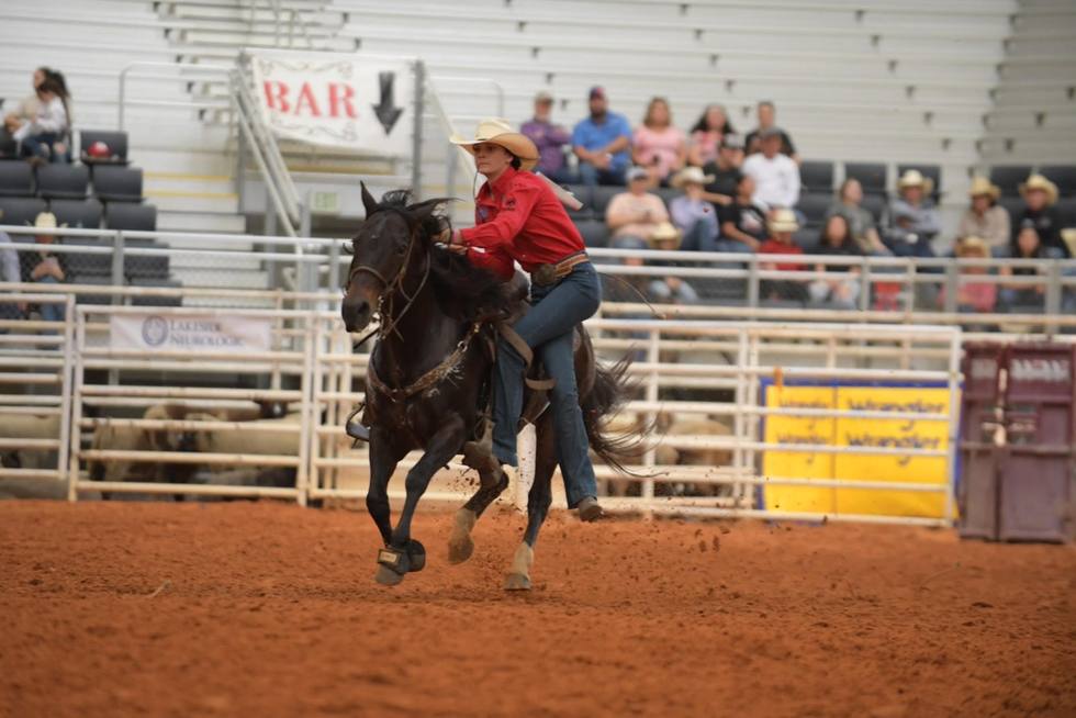 Barrel racer rounding a barrel at the Mosaic Arena
